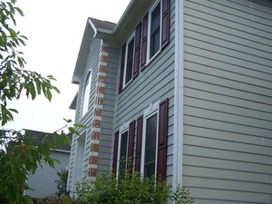 Exterior Painting being performed by an experienced R and R Painting NC LLC painter.